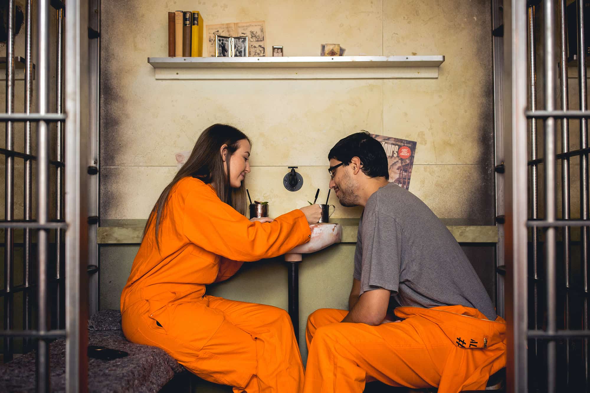 Couple enjoying date night at Alcotraz - prison-themed immersive cocktail experience for romantic evenings.